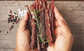 Beef jerky on hands