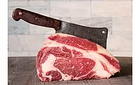 Raw prime rib beef with meat cleaver. Raw prime rib beef with meat cleaver.