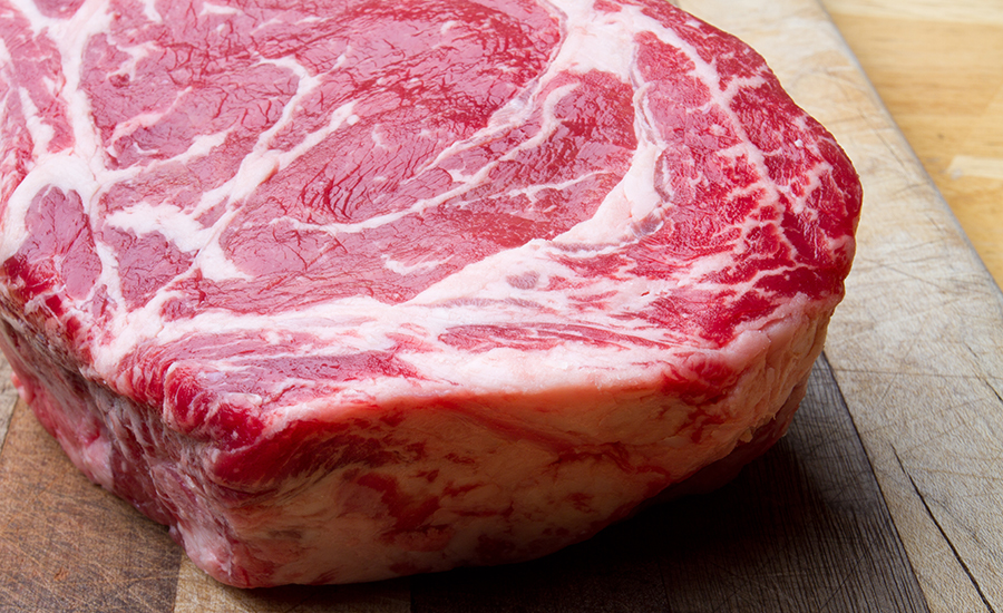 Thick Bone-In Rib Eye Steak on a cutting board