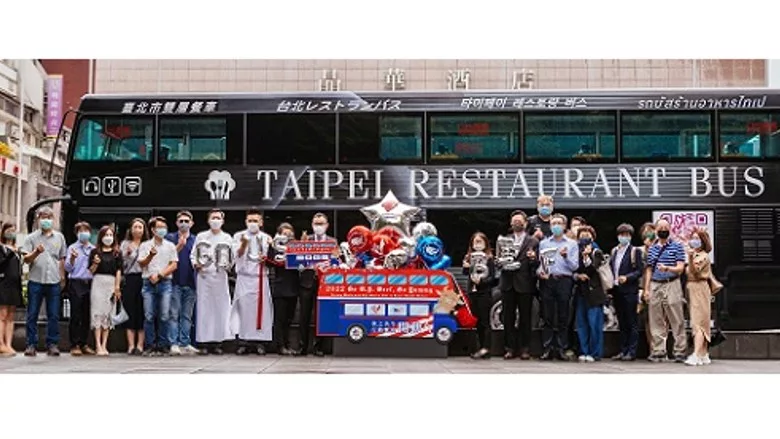 VIP passengers in front of a double-decker bus that took them through Taipei.