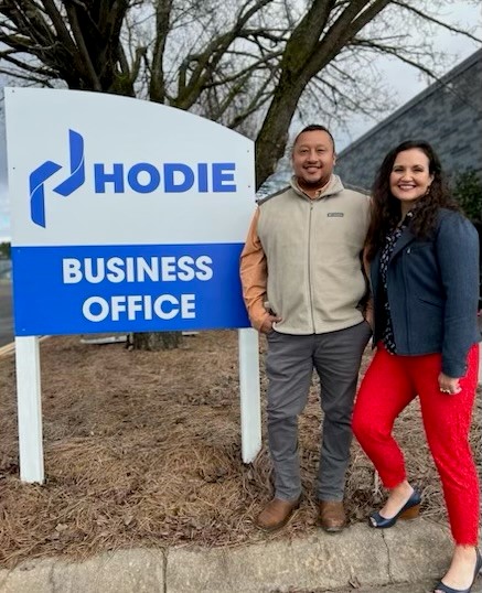 Hodie Meats Vice President of Processing Ben Garcia and Vice President of Sales Amy Ward stand next to the Hodie Meats Business Office sign