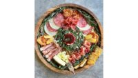 Christmas wreath made out of charcuterie, cheese and rosemary