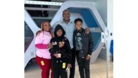 Boxing legend Evander Holyfield poses with a family during his visit to Joe DiMaggio Children’s Hospital in Hollywood, Florida.