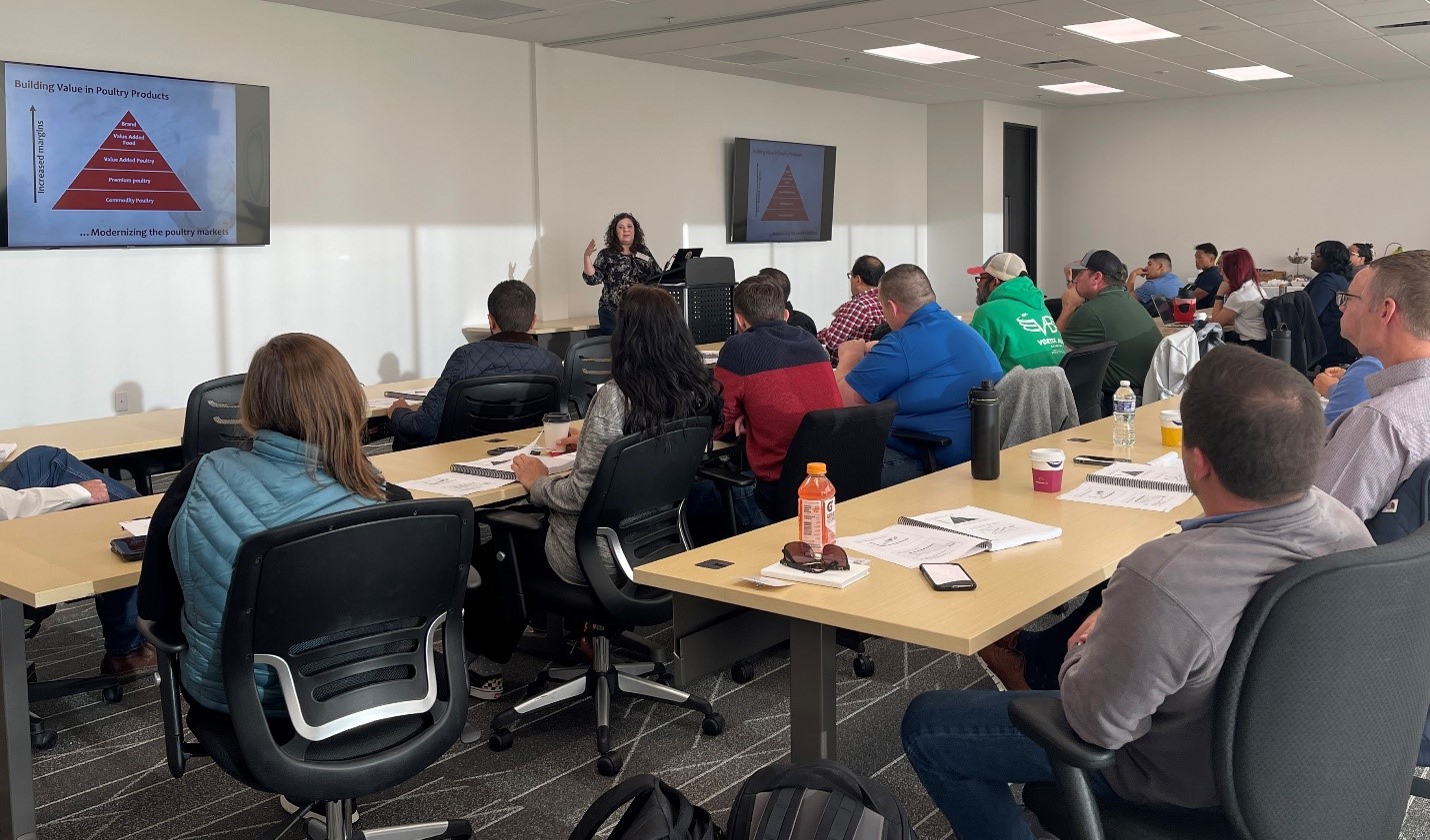 The comprehensive Poultry 201 program, with Dr. Casey Owens (pictured at the podium), professor of poultry science at the University of Arkansas