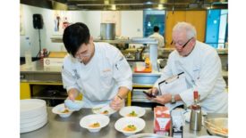 Judge/Chef Roland Passot (right) evaluates contestant Marcus Youn during the chef competition of Young Chef Young Waiter U.S.A.