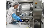 Kourtney Gardner places chicken breasts into a Reepack E10 Thermoformer