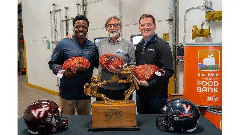 Smithfield, Blue Ridge Area Food Bank and University of Virginia represenatives presenting a food donation as part of the Smithfield Commonwealth Clash