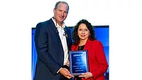 Marla Robison from Aviagen accepting the long-time exhibitor plaque from Mikell Fries (left), USPOULTRY chair and Claxton Poultry Farms.