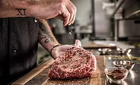 man seasoning meat