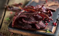 Beef Jerky on a Rustic Wooden Table Beef Jerky on a Rustic Wooden Table