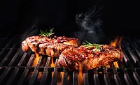 Beef steaks on the grill with flames Beef steaks on the grill with flames