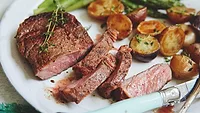 Ribeye sliced and plated with potatoes and asparagus Ribeye sliced and plated with potatoes and asparagus