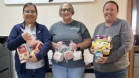 Smithfield Foods employees pack donated food items into boxes for the Laverne Food Pantry in Laverne, Okla.
