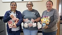 Smithfield Foods employees pack donated food items into boxes for the Laverne Food Pantry in Laverne, Okla.