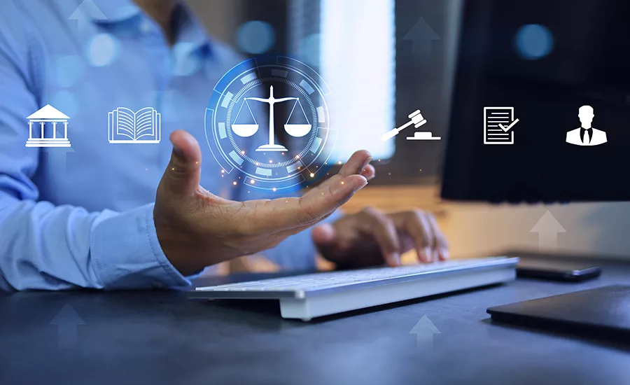 Law regulation concept. Businessman or lawyer holding balance of justice to legal study on computer application.