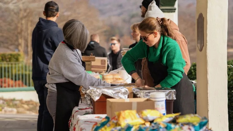 Volunteers distributing brisket to residents at Christmas for Chimney Rock