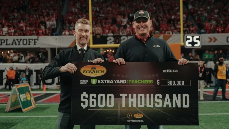 ESPN’s Marty Smith and Smithfield's Steve France present the $600,000 check