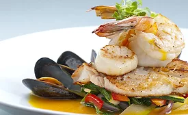 Seafood medley of shrimp, scallops, mussels and fresh fish over a bed of vegetables.