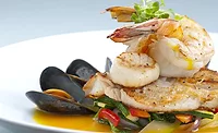 Seafood medley of shrimp, scallops, mussels and fresh fish over a bed of vegetables.