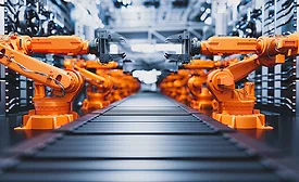 Robotic arms along assembly line in modern factory.