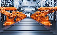 Robotic arms along assembly line in modern factory.