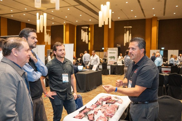 Alfonso Terrazas (right), director of international sales for Creekstone Farms Premium Beef, meets with prospective buyers at the USMEF Latin American Product Showcase 