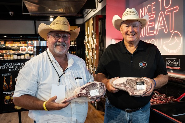 Cattle producers Mark Goes of the Nebraska Beef Council (left) and Steve Hanson, chair of the US Meat Export Federation, display US beef cuts available at a Guatemala City supermarket.