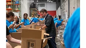 Shane Smith, president and CEO of Smithfield Foods, and local employees helped pack boxes of food for neighbors in need during a volunteer event at the Virginia Peninsula Foodbank.