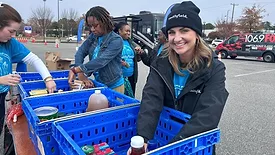 Jessica Scarlett, brand manager, Smithfield Foods, organizes donated food items during the Mayflower Marathon Holiday Food and Fund Drive.