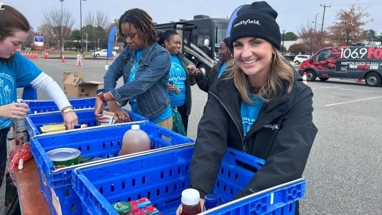 Jessica Scarlett, brand manager, Smithfield Foods, organizes donated food items during the Mayflower Marathon Holiday Food and Fund Drive.