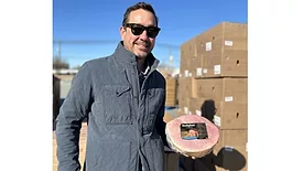 Keller Watts, chief business officer, Smithfield Foods, volunteers at the Season of Serving food distribution event in Smithfield, Va.