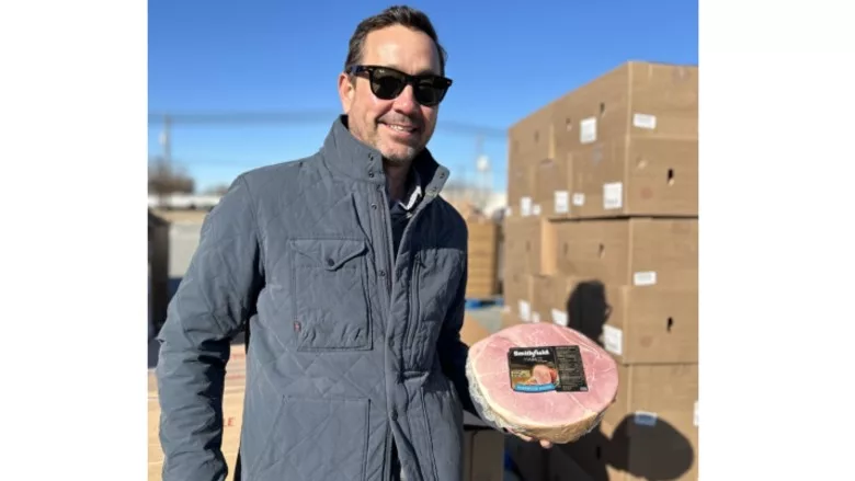 Keller Watts, chief business officer, Smithfield Foods, volunteers at the Season of Serving food distribution event in Smithfield, Va.