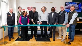 Charcuterie Artisans executives and local elected officials pose as the ribbon is cut to open the innovation center.