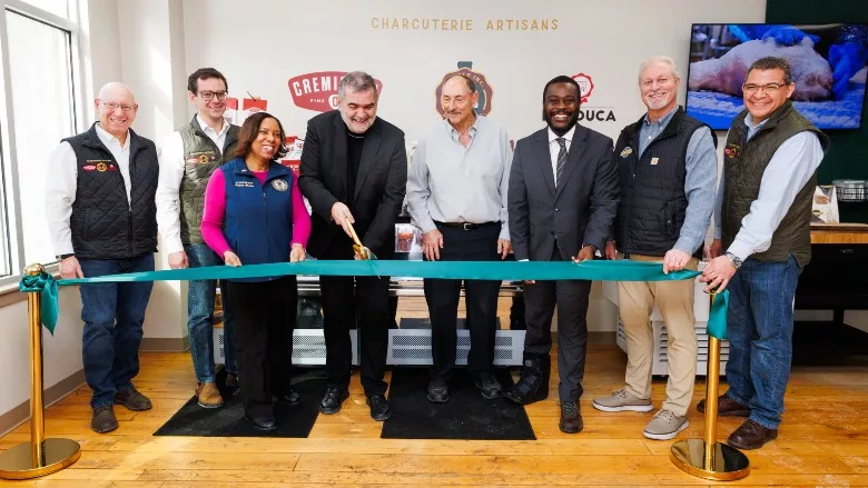 Charcuterie Artisans executives and local elected officials pose as the ribbon is cut to open the innovation center.