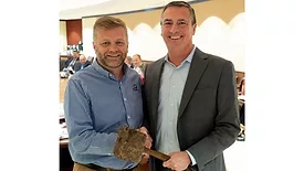 2026 US Poultry & Egg Association Chair Bill Griffith, Peco Foods, receives the traditional “working man’s gavel” by Immediate Past Chair Jonathan Cade, president for Hy-Line International.