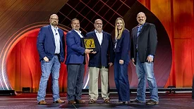 Sysco representatives Joe Don Eilers and Jeremy Melloan (second and third from left, respectively), receive the 2026 Beef Quality Assurance Marketer of the Year award at NCBA Cattle Convention.