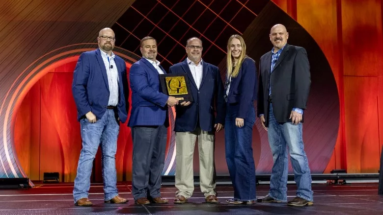 Sysco representatives Joe Don Eilers and Jeremy Melloan (second and third from left, respectively), receive the 2026 Beef Quality Assurance Marketer of the Year award at NCBA Cattle Convention.