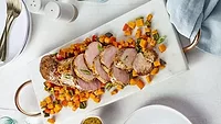 Garlic Dijon pork tenderloin served with roasted sweet potatoes and bell peppers