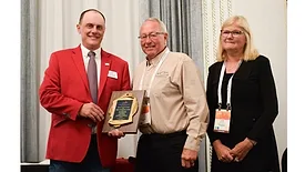 AAMP's Shane Flowers presents Terry and Jody Kerns with the Achievement Award
