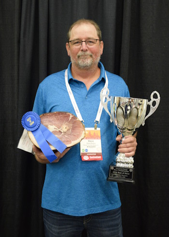 Steve Bolton, owner of Woods Smoked Meats, accepts the Clarence Knebel Memorial Best in Show Award