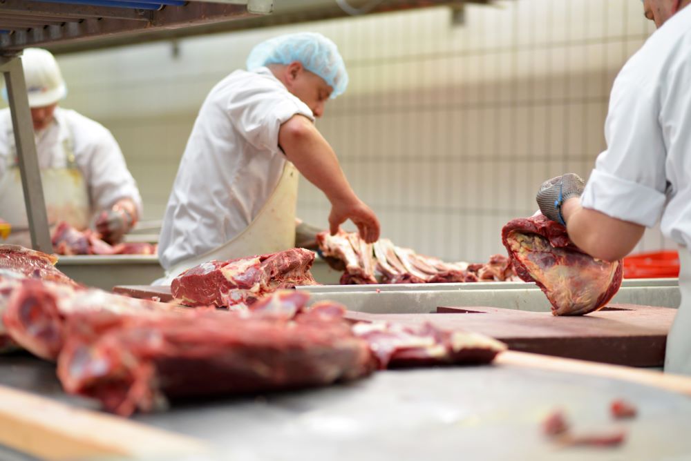 men slicing meat