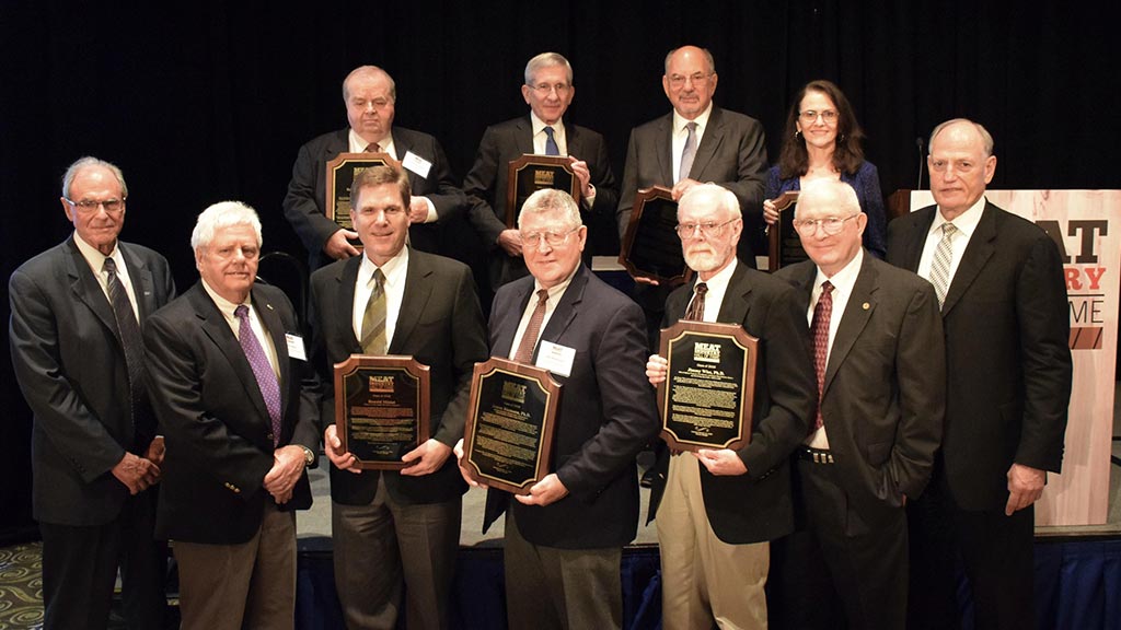 A group of Meat Industry Hall of Fame winners displaying their awards