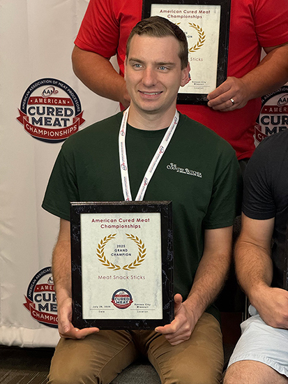 Nick Boyer with the Grand Champion award for Meat Snack Sticks.