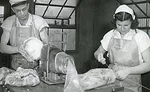 Armour employees prepare boneless hams for smoking