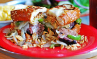 City Barbeque’s More Cowbell sandwich includes beef brisket, topped with peppers, smoked provolone, onions and creamy horseradish sauce piled high on Texas toast
