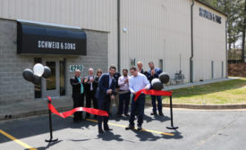 Jamie and Brad Schweid cut the ribbon to officially open the new Schweid & Sons facility in College Park, Ga.
