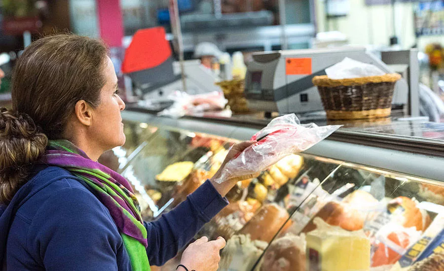 Woman Purchasing Lunch Meat From Deli