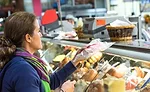 Woman Purchasing Lunch Meat From Deli