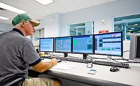 A meat & poultry plant worker uses a computer-based system for record keeping