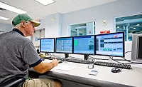 A meat & poultry plant worker uses a computer-based system for record keeping